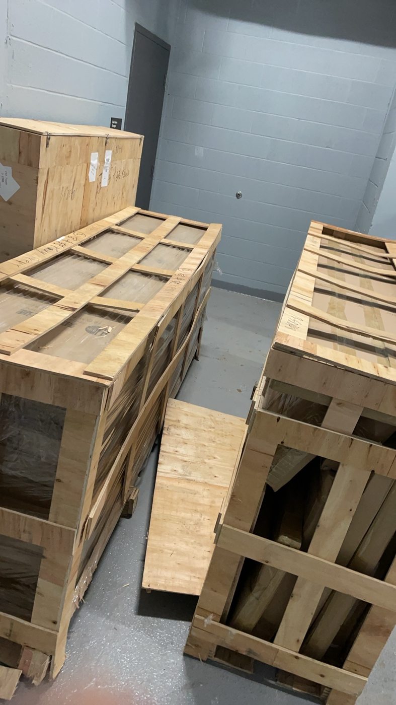 Large furniture pieces arriving in protective wooden crates