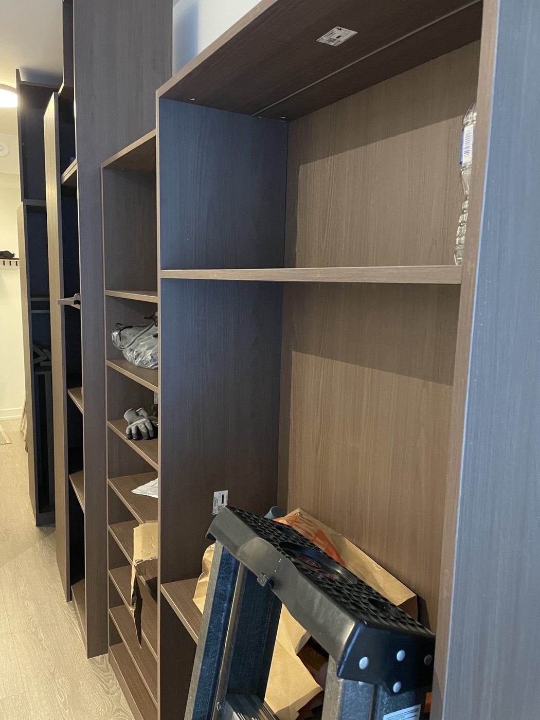 Tall shelving units assembled in a condo
