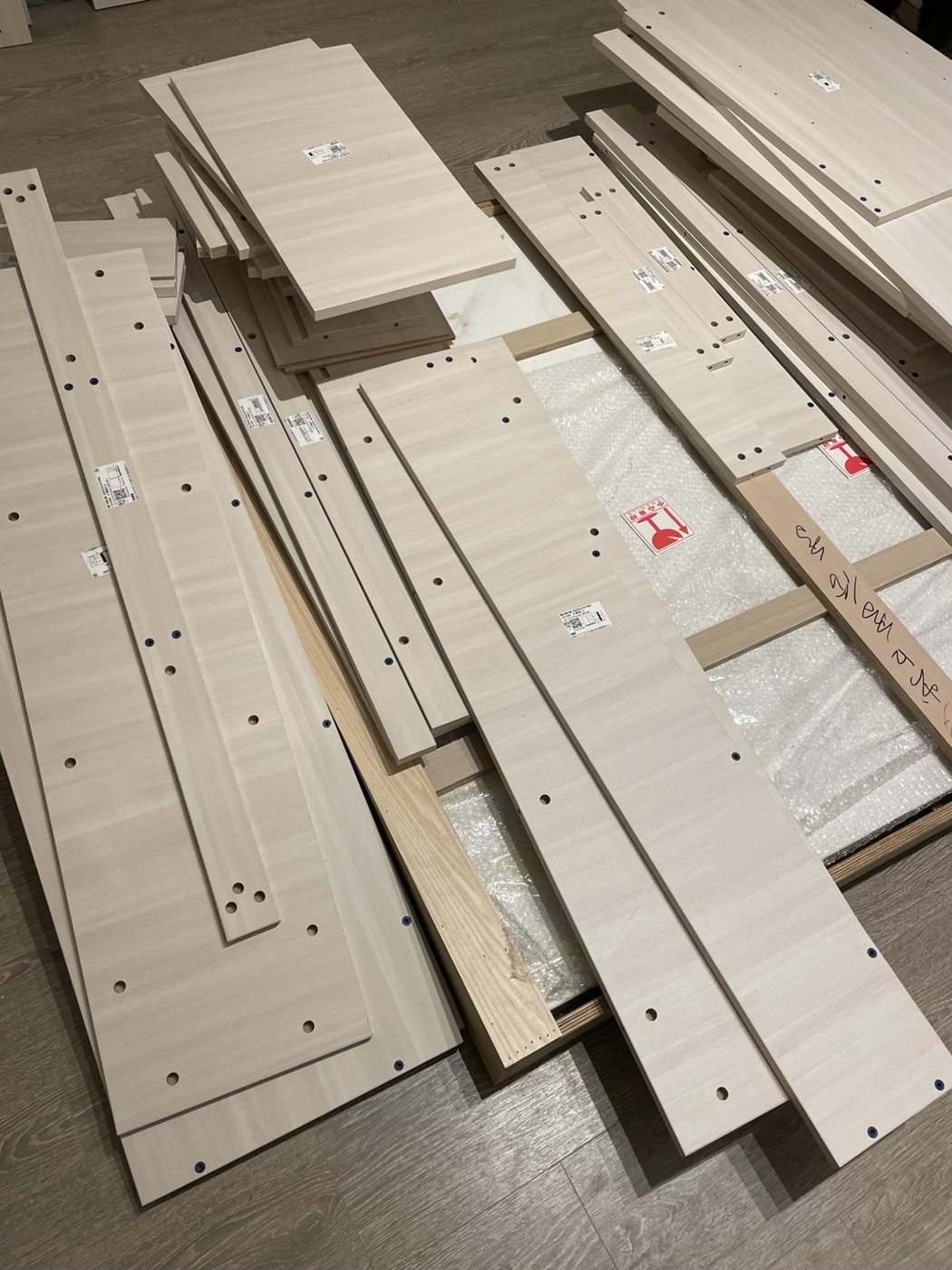 Unpacked wood panels laid out before furniture assembly